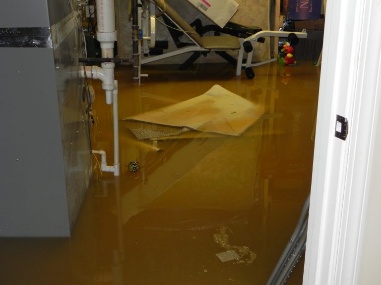 Restoration crew deploying industrial water extraction vacuums in flooded building
