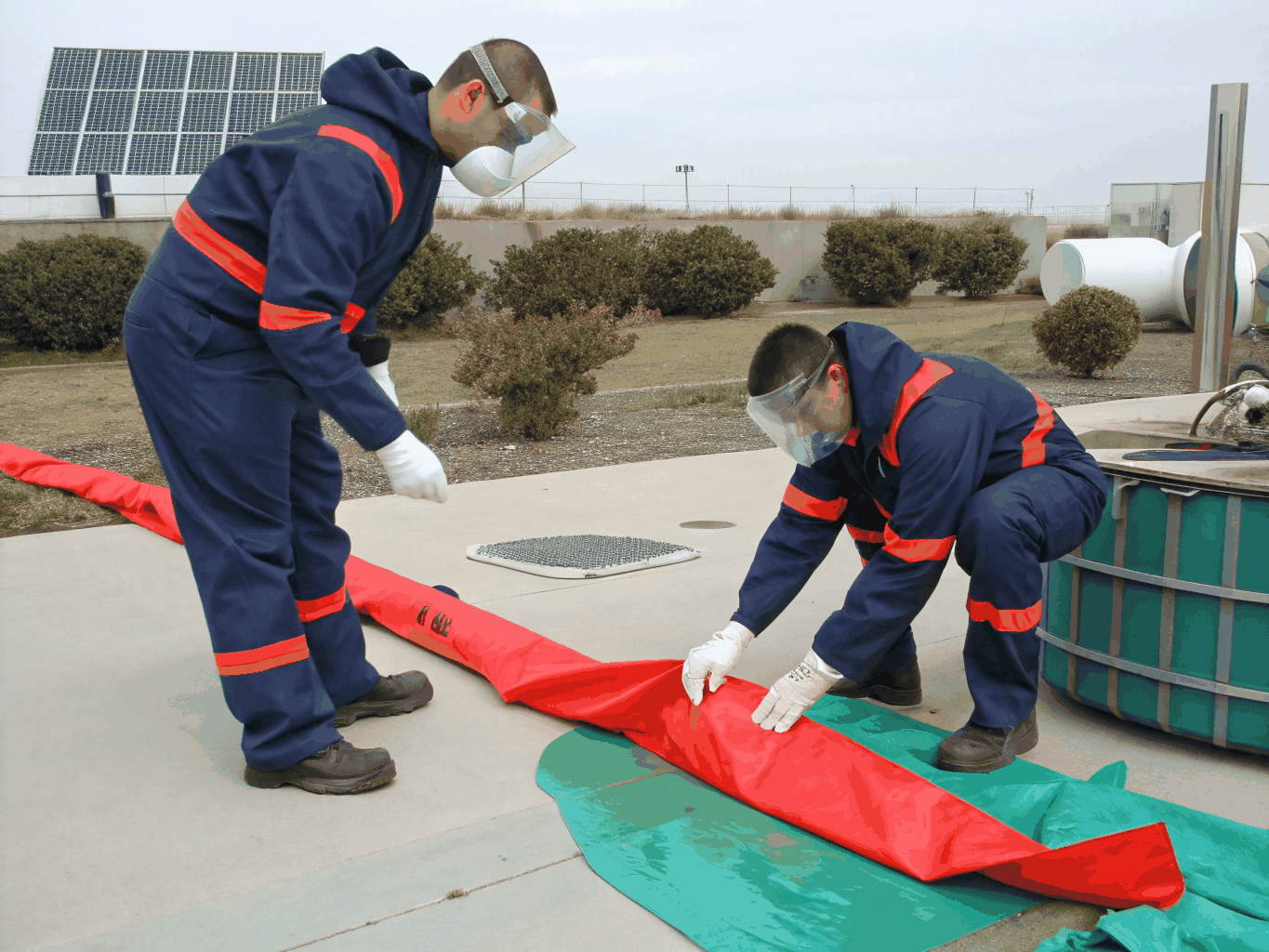 Technicians in protective suits handling certified sewage and biohazard cleanup