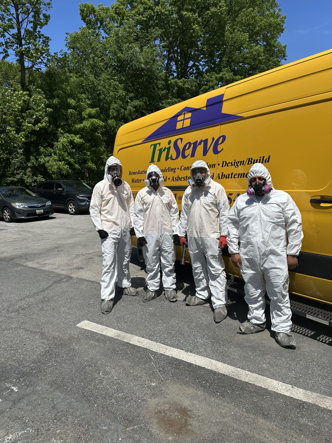 Technicians in protective suits handling certified sewage and biohazard cleanup